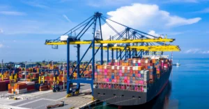 A large cargo ship loaded with colorful shipping containers, The blue sky hints at smooth sailing, ideal for keeping FBA shipping costs efficient and timely.