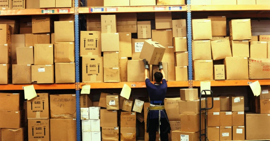 China Buying Agent: Benefits & Risks Every Importer Must Know 1 employee managing packages in china warehouse